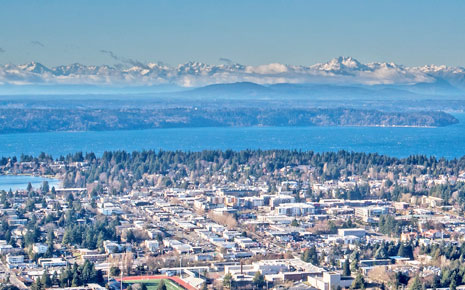 Aerial view of Burien with water and mountains in the distance